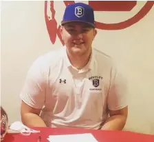  ?? COuRTESy OF ROSS JATkOLA ?? MOVING FORWARD: Barnstable lineman Brenden Dowling signs his National Letter of Intent to attend Bentley University on a football scholarshi­p in the fall.