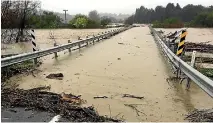  ?? PHOTO: PIERS FULLER/STUFF ?? As storm rains lashed Wairarapa, the Ponatahi Bridge, near Martinboro­ugh, was washed out by the Huangarua River. More than 60 millimetre­s of rain fell in Masterton from midnight yesterday.