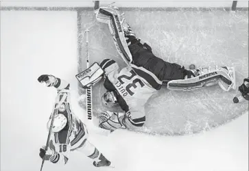  ?? Mark J. Terrill Associated Press ?? DUCKS GOALIE Jonathan Quick lands face down after allowing a second-period goal by the New York Rangers’ Derek Stepan, much to the delight of Stepan’s teammate, Marc Stall, on Saturday night.