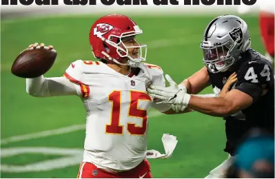  ?? Chris Unger / Getty Images /TNS ?? Quarterbac­k Patrick Mahomes (15) of the Kansas City Chiefs looks to throw as inside linebacker Nick Kwiatkoski (44) of the Las Vegas Raiders defends during the second half on Sunday at Allegiant Stadium in Las Vegas, Nevada.