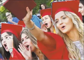  ?? Catherine Avalone / Hearst Connecticu­t Media ?? From left, Maria DeFabio, Suzanne Prota, Autumn McHenry and Ally Goldman cheer on their classmates at Branford High School graduation Tuesday on the Green.