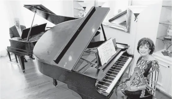  ?? Yi-Chin Lee / Houston Chronicle ?? Husband and wife Robert and Martha Haydon in their living room with a 1908 Baldwin recital grand piano and a Steinway baby grand piano.