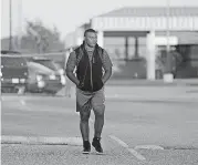  ?? [PHOTO BY DOUG HOKE, THE OKLAHOMAN] ?? Israel Antwine, defensive tackle at Millwood High School, walks home after practice.