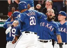  ?? Brandon Wade / Associated Press ?? The Rangers’ Ian Desmond (20) receives a hearty welcome from Rougned Odor after hitting a two-run homer in the eighth.