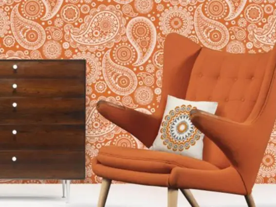  ??  ?? Mini Moderns gives paisley a retro twist for wallpaper, mugs and textiles. Crescent wallpaper is £45 a roll in Tangerine Dream, shown, or Lido blue