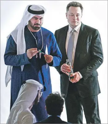  ?? AFP/Getty Images ?? MOHAMMED GERGAWI, left, United Arab Emirates minister of Cabinet Affairs and Future, with Tesla Chief Executive Elon Musk at the World Government Summit 2017 in Dubai last year.