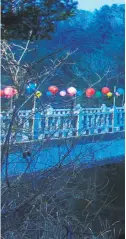  ??  ?? Lanterns line a bridge near Woljeongsa Temple. The colored lanterns light the way amid the trees along trails in Odaesan National Park.