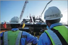  ?? ZU KANAN / XINHUA ?? Workers inspect a bridge built for the Jakarta-Bandung bullet train line in Purwakarta, West Java.