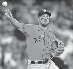  ?? GARY A. VASQUEZ/USA TODAY SPORTS ?? Astros third baseman Alex Bregman throws to first base for an out against the Dodgers on Sunday in Los Angeles.