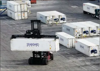  ?? (AP/Marta Lavandier) Containers are moved at Port Miami in late January in Miami. ??