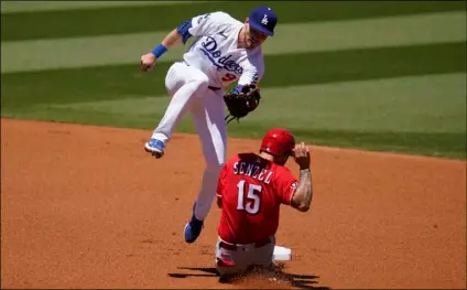  ?? AP Photo/Marcio Jose Sanchez ?? Cincinnati Reds’ Nick Senzel (15) steals second base as Los Angeles Dodgers shortstop
Gavin Lux catches a high throw from home plate during the first inning of a baseball game on Wednesday in Los Angeles.