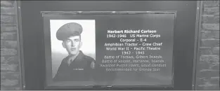  ?? BILL LEUKHARDT/HARTFORD COURANT ?? Informatio­n on World War II veteran Herbert Carlson is included in Berlin’s new video wall of honor in the Town Hall lobby.
