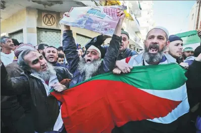 ?? SHEN JIZHONG / XINHUA ?? Algerian people protest against US President Donald Trump’s decision to recognize Jerusalem as the capital of Israel in Algiers on Friday.