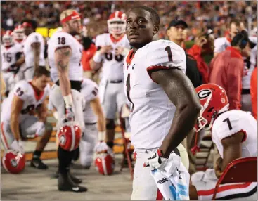  ??  ?? Curtis Compton / AJC via AP Georgia tailback Sony Michel watches Auburn score a touchdown in the third quarter of last week’s game.