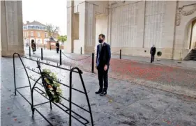  ?? KURT DESPLENTER, POOL VIA AP ?? Belgium’s Prime Minister Alexander De Croo takes a moment of silence Wednesday after placing a wreath during an Armistice Day ceremony at the Menin Gate Memorial to the Missing in Ypres, Belgium.