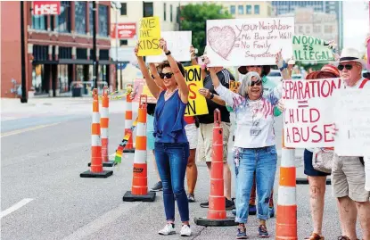  ?? [PHOTO BY ANYA MAGNUSON, THE OKLAHOMAN] ?? People at the Keep Families Together Rally hold signs outside the office of Sen. James Lankford, R-Oklahoma City, on Monday. The rally was in protest of the separation of families and internment of immigrant children.
