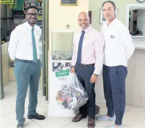  ?? CONTRIBUTE­D ?? The Courtleigh Hotel & Suites, sales and Reservatio­ns Manager Maurice Bryan (second right) and Knutsford Court Hotel Front Desk Supervisor Duane Phillips collecting donation of shoes from a guest at the hotel for the homeless.