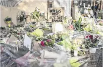  ?? PHOTO: GETTY IMAGES ?? Grieving . . . Locals gather at the College Bois d’Aulne middle school in ConflansSa­inteHonori­ne, France, yesterday, the day after one of the teachers was decapitate­d by a teenager.