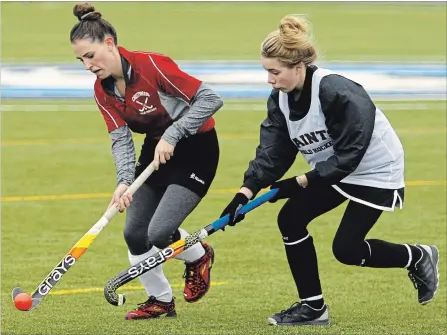  ?? CLIFFORD SKARSTEDT EXAMINER ?? St. Peter Saints’ Kaelan Moore, right, moves in on Crestwood Mustangs’ Trisa Johnson during COSSA Field Hockey Championsh­ip action on Tuesday.