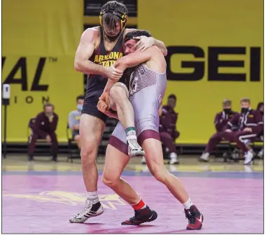  ?? (Photo courtesy of UALR) ?? UALR’s Triston Wills (right), shown competing against Arizona State on Jan. 2, underwent brain surgery after suffering an injury before his sophomore year of high school in Kansas. He returned to the mat six months later and eventually won two state championsh­ips before signing with Oklahoma State and then transferri­ng to UALR.