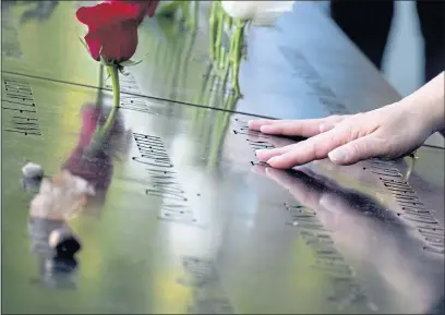  ?? CRAIG RUTTLE — NEWSDAY ?? Hands on Saturday touch the names of people who were killed during the attacks on the World Trade Center at the National September 11 Memorial in New York on the 20th anniversar­y of the attacks.