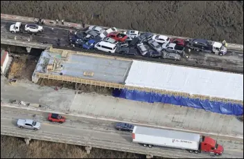  ?? Rob Ostermaier/The Daily Press via AP ?? Crews work to clear vehicles from the Queens Creek overpass on I-64 in York County, Va., Sunday after a chain-reaction crash involving multiple vehicles cars. The crash happened Sunday morning.