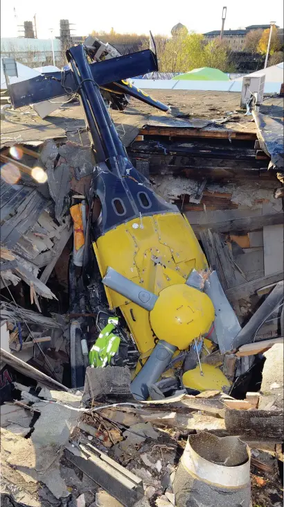  ??  ?? Aftermath: The wreckage of the Eurocopter EC13 amid the ruins of the bar two days after crash