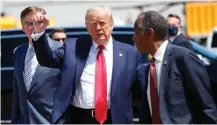  ?? AP ?? PRESIDENT Donald Trump walks with Texas Lieutenant Governor Dan Patrick, left, and Housing and Urban Developmen­t Secretary Ben Carson as he arrives on Air Force One at Dallas Love Field. |