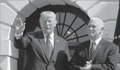  ?? AP PHOTO ?? President Donald Trump, left, with Vice President Mike Pence, waves after speaking about the economy from the South Lawn of the White House, Friday in Washington.