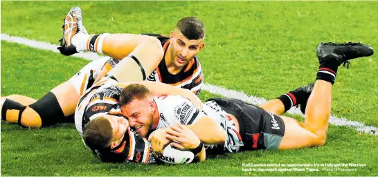  ?? Photo / Photosport ?? Karl Lawton scored an opportunis­tic try to help get the Warriors back in the match against Wests Tigers.