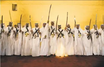  ?? Stephen Crowley / New York Times ?? Swords raised, men participat­e in a victory dance at the Murabba Palace in Riyadh, Saudi Arabia, where President Trump dined with King Salman on Saturday. Trump, who received a fawning reception during his visit, joined in at one point.