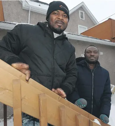  ?? KEVIN KING / POSTMEDIA NEWS ?? Razak Iyal, left, and Seidu Mohammed in the backyard of Iyal’s apartment in Winnipeg. The two men from Ghana lost nine fingers between them after walking across the border between the U.S. and Canada last Christmas Eve.