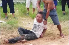 ?? SUPPLIED ?? Villagers drag a man wrongly accused of kidnapping after he was beaten by an angry mob on Saturday in Preah Sihanouk province.