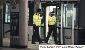  ??  ?? Police board a tram in old Market Square