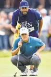  ?? Stuart Franklin / Getty Images ?? Jordan Spieth and caddie Michael Greller line up a putt on the fourth green at Royal Birkdale on Sunday.