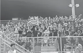  ??  ?? The White Station student section celebrates during the Spartans' seasonopen­ing win against Melrose on Saturday.