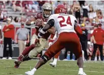  ?? COURTESY OF DON JUAN MOORE/ACC ?? FSU quarterbac­k Jordan Travis avoids getting tackled by Jacksonvil­le State linebacker Zack Woodward on Oct. 3.