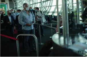  ?? FRANCISCO SECO THE ASSOCIATED PRESS ?? Passengers line up to board their plane to Marseille at the Zaventem airport in Brussels on Monday. European countries have opened their borders to visitors from within the continent.