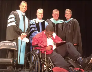  ?? EVAN BRANDT — MEDIANEWS GROUP ?? Pottsgrove senior JaSaad Jamison, seated, received an early graduation ceremony Thursday. He has been diagnosed with a terminal brain tumor. At rear from left are Pottsgrove Superinten­dent William Shirk, Assistant Superinten­dent Robert Harney, High School Principal William Ziegler, and life skills teacher, Melissa DeStefano.