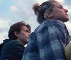  ?? — Amazon Studios ?? Moody teens played by Austin Abrams (left) and Lili Reinhart look off into the distance in Chemical Hearts.