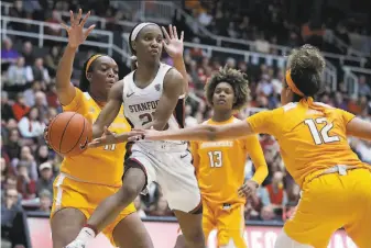  ?? Ben Margot / Associated Press ?? Stanford’s Kiana Williams looks to pass away from Tennessee’s Rae Burrell (right) during the second half. Williams scored a gamehigh 19 points and dished out seven assists.