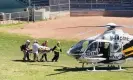  ?? Photograph: @HoratioGat­es3/EPA ?? Salman Rushdie is loaded into a medevac helicopter after he was attacked while on stage at an event in Chautauqua, New York.