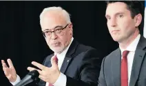  ?? ALLEN McINNIS ?? Finance Minister Carlos Leitão, left, with Transport Minister André Fortin, said Friday that the province had to work within the parameters of an overall compensati­on package of $250 million for cab drivers who have seen their permits’ value plummet with the arrival of Uber.