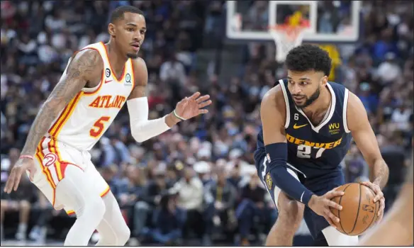  ?? DAVID ZALUBOWSKI — THE ASSOCIATED PRESS ?? Nuggets guard Jamal Murray, right, looks to pass as Hawks guard Dejounte Murray defends during the second half Saturday at Ball Arena in Denver.