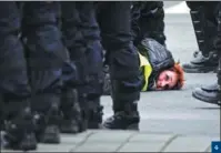  ?? GEERT VANDEN WIJNGAERT / AP ?? 4. A woman wearing a yellow vest is detained by police during a demonstrat­ion in Brussels on Dec 8. 4