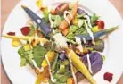  ??  ?? The roasted rainbow salad includes baby carrots, goat cheese and sunflower seeds.