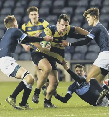  ??  ?? Strathalla­n’s Alex Marsh is challenged by Glenalmond’s Tom Porter at BT Murrayfiel­d last night.