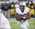  ?? TONY DING — THE ASSOCIATED PRESS ?? Penn State running back Saquon Barkley (26) rushes in the fourth quarter against Michigan at Michigan Stadium in Ann Arbor, Mich.