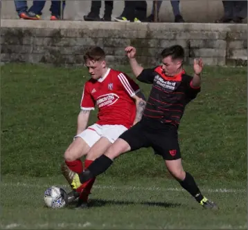  ??  ?? Dillon Redmond of Moyne Rangers is challenged by Mark Mythen of Bridge Rovers.