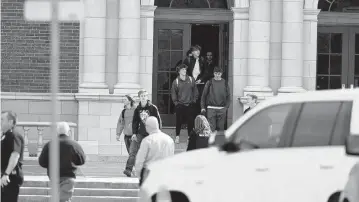  ?? HYOUNG CHANG The Denver Post ?? Students leave Denver’s East High School after the lockdown was lifted following Wednesday’s shooting. ‘We’re scared to go to school. We want to have these legislator­s look us in our eyes when they tell us they won’t pass gun legislatio­n,’ said sophomore student Anna Hay at a rally Thursday at the state Capitol.